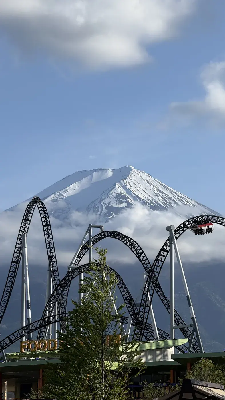 Mount Fuji behind the curves of a roller coaster