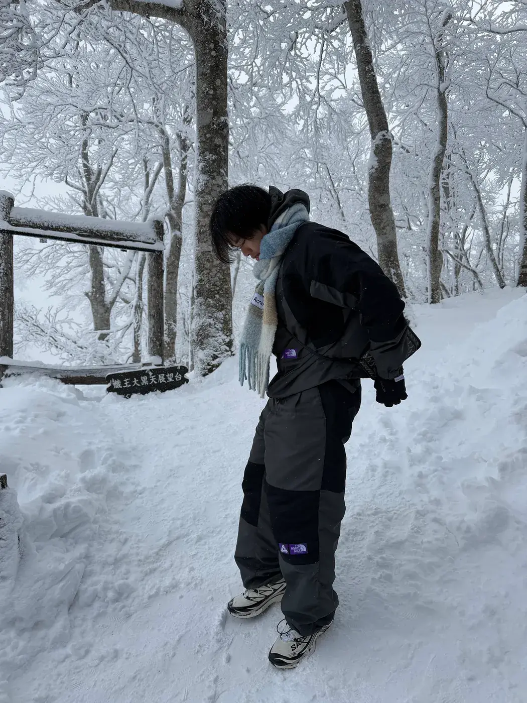 Elliot in a snowy forest wearing a blue scarf