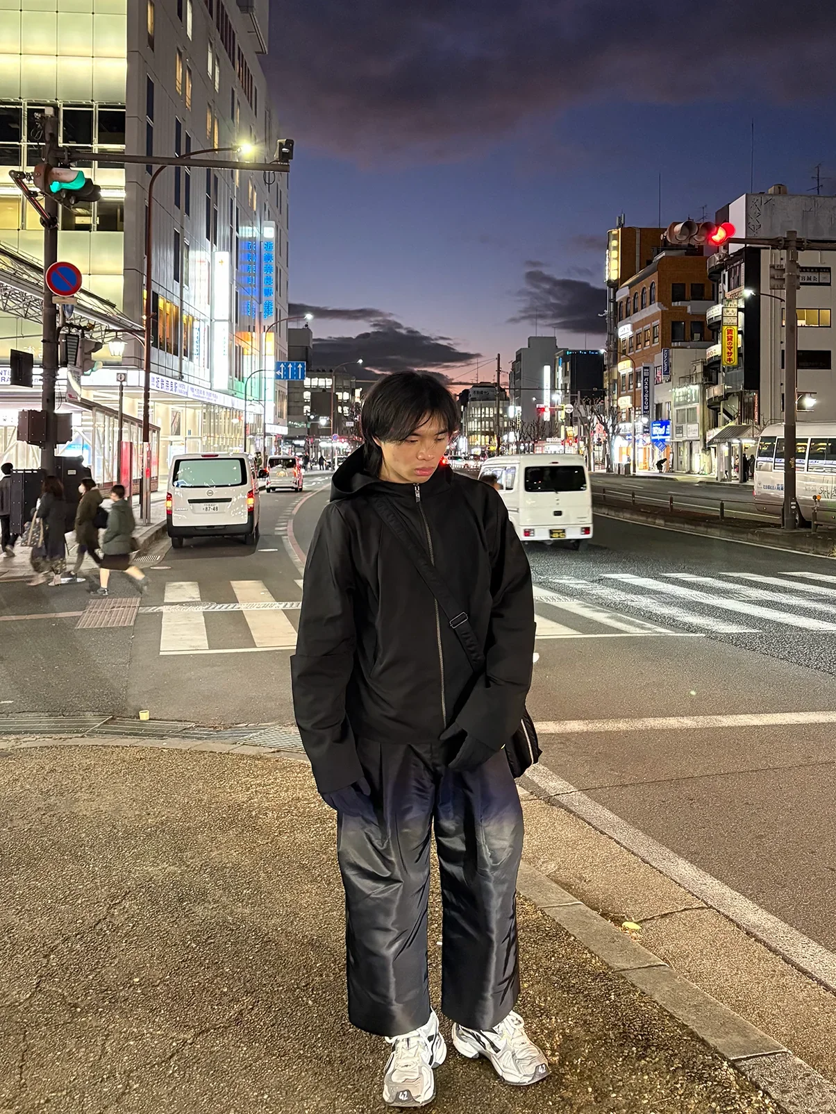 Elliot standing on a city street in Japan at night